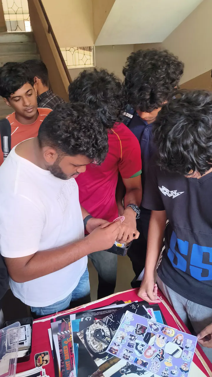 A crowd of students picking stickers at the stall