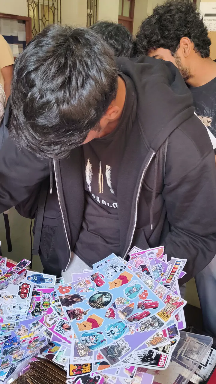 A customer looking through sticker sheets